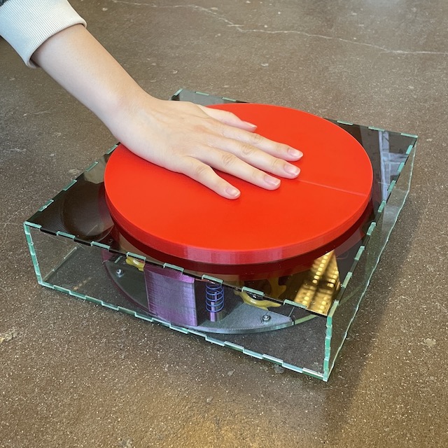 wheeled robot disguised as big red button